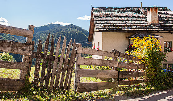 A fence and house in the village of La Valle