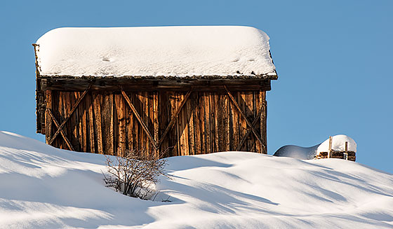 View of a snowy wooden house