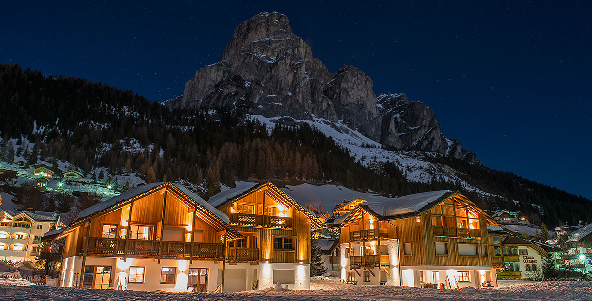 View of some houses of the village of Corvara illuminated at night in winter
