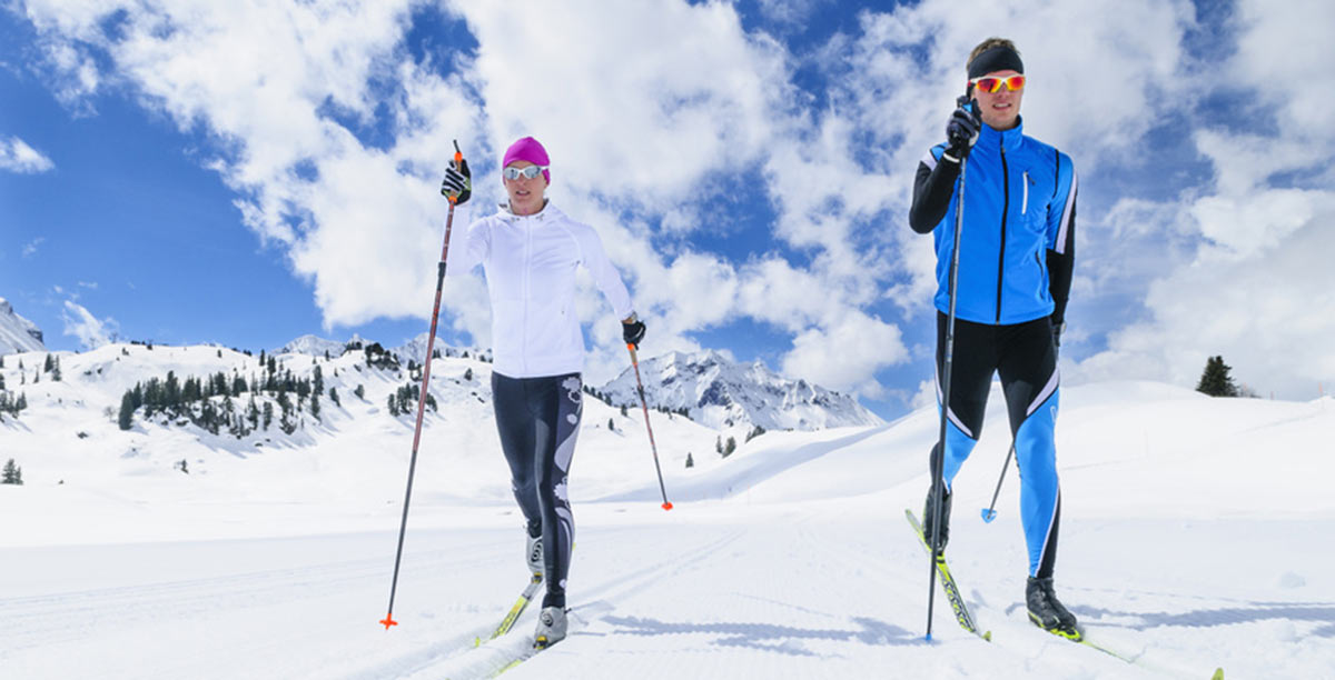 Two cross-country skiers can ski along a marked route for cross-country skiing