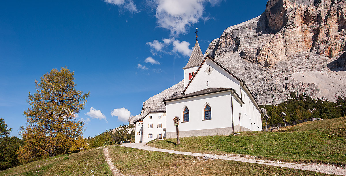 A small mountain church at the base of a mountain